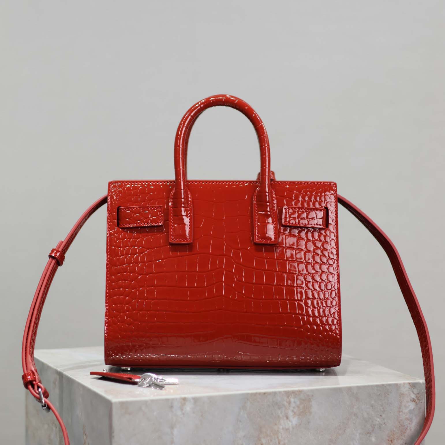 Close-up of gold-tone YSL hardware on Saint Laurent YSL Women Sac De Jour Nano-Red