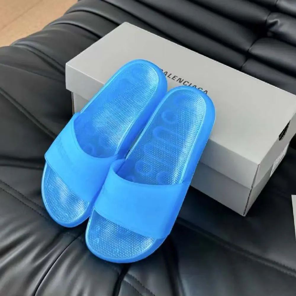 Close-up of translucent strap and embossed logo on Balenciaga slide sandal