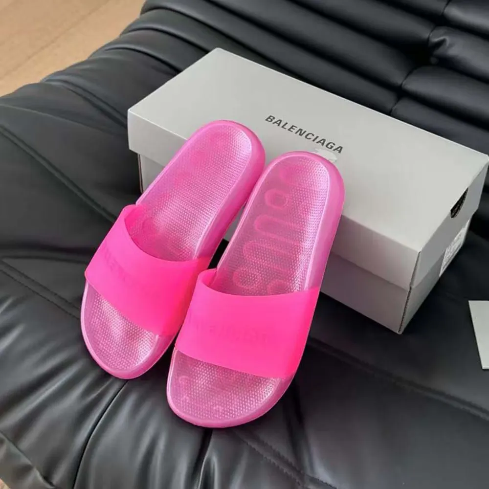 Close-up of embossed Balenciaga logo on pink transparent slide sandal