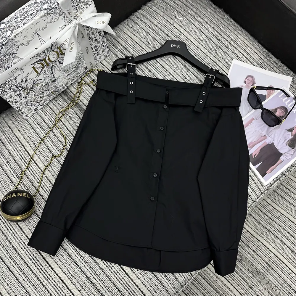 Close-up of Dior logo buttons on black cotton poplin blouse