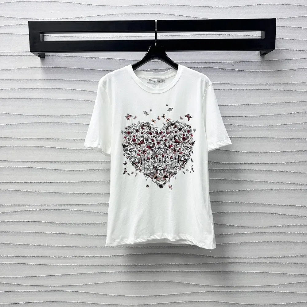 Close-up of Dioramour embroidery detail on white cotton linen t-shirt
