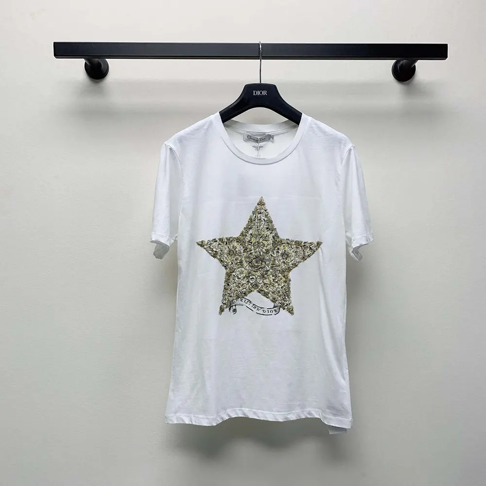 Close-up of Dior embroidery detail on white cotton-linen t-shirt