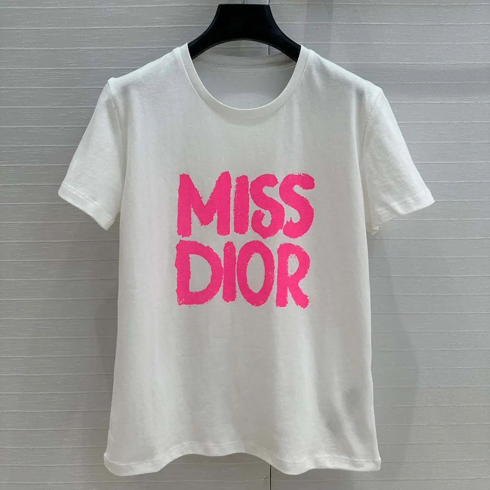 Close-up of bright pink Miss Dior graffiti on white cotton jersey t-shirt