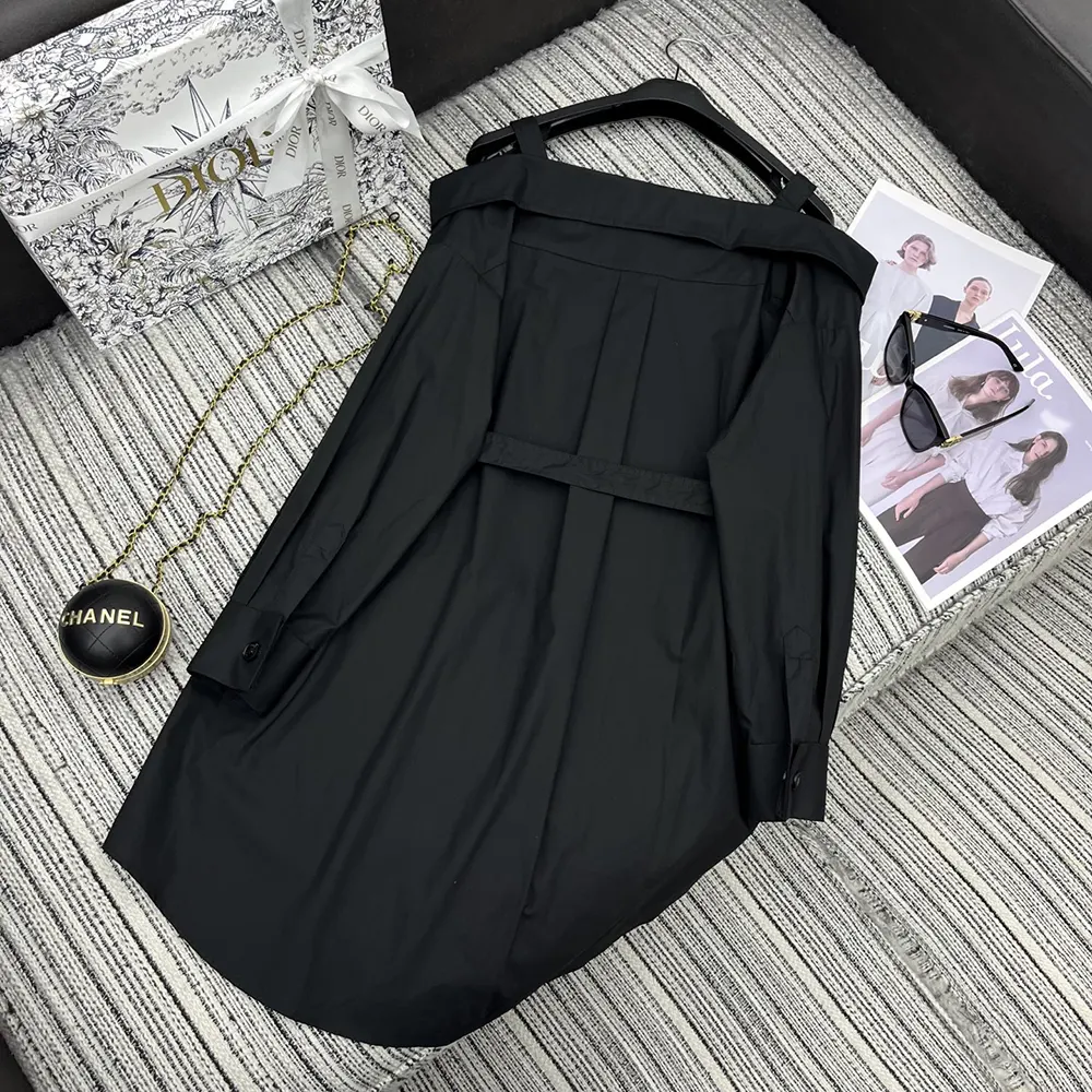 Close-up of Dior signature buttons on black shirtdress