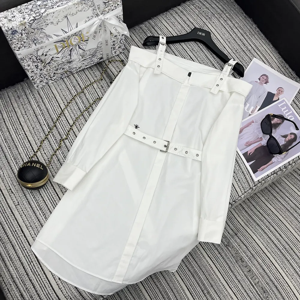 Close-up of Dior engraved buttons on white shirtdress