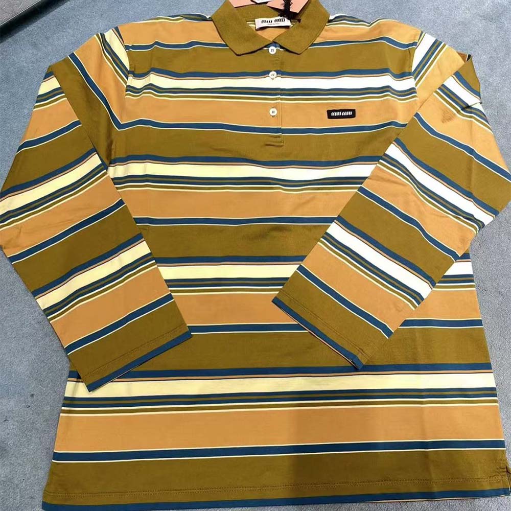 Close-up of button placket with Miu Miu logo buttons on polo shirt