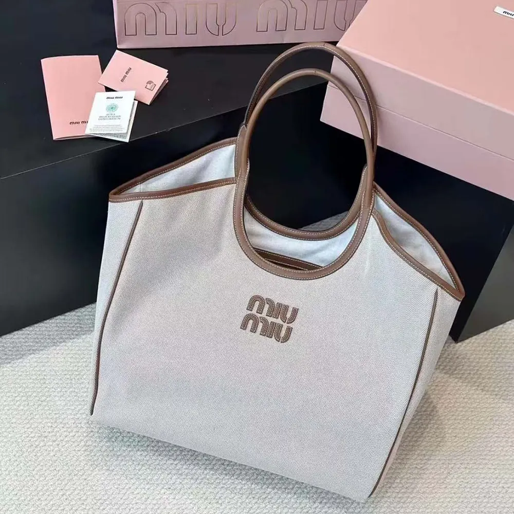 Side angle showing spacious interior of Miu Miu Women IVY Canvas Tote Bag