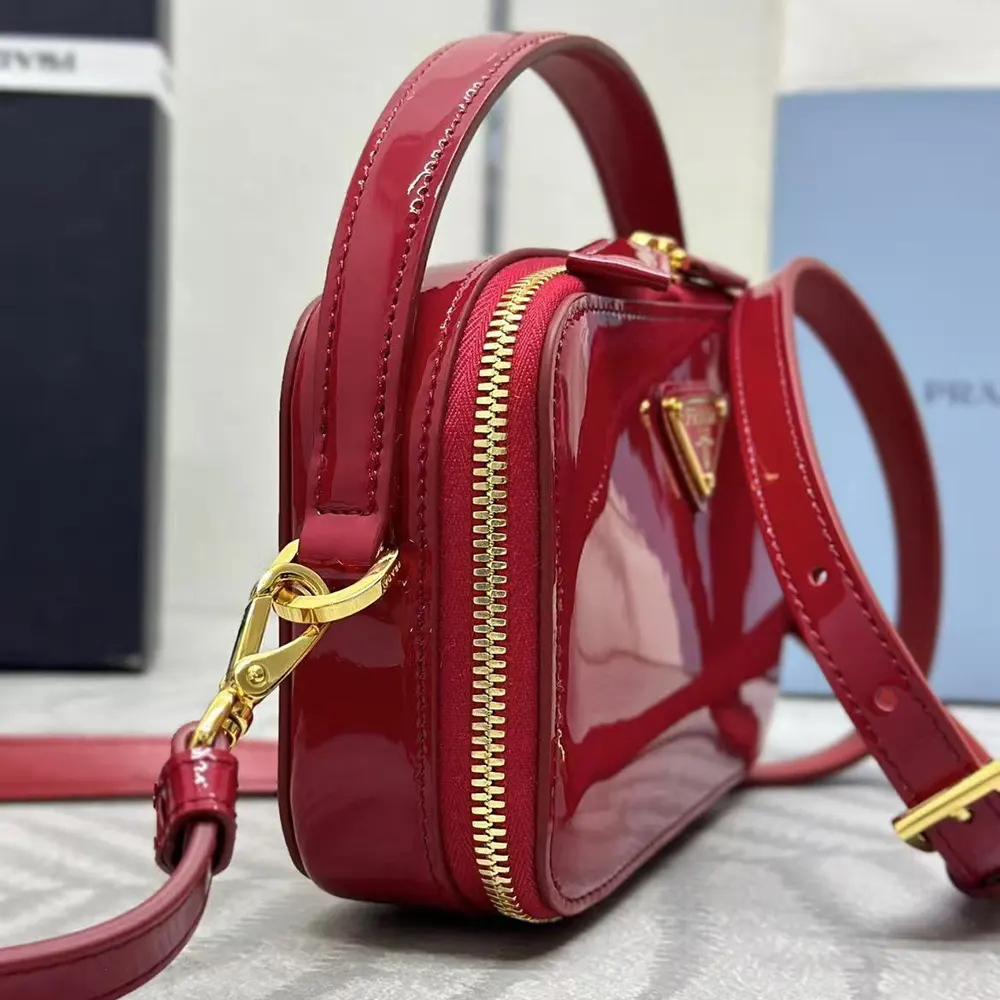 Side profile showing compact silhouette of Prada Women Odette Mini-bag in red