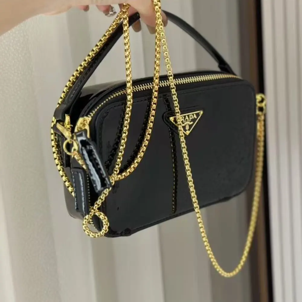 Side angle showing silhouette of Prada Women Odette Patent Leather Mini-bag-Black