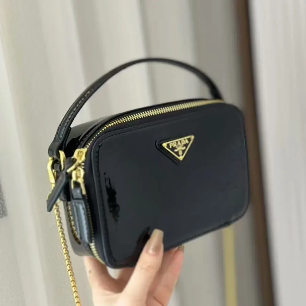 Close-up of Prada Women Odette Patent Leather Mini-bag-Black patent leather texture