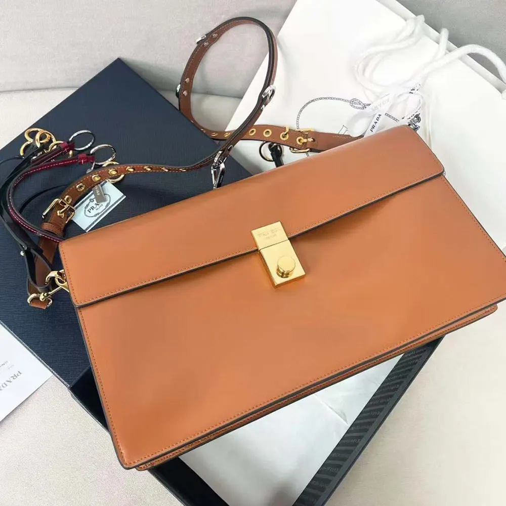 Close-up of gold-tone hardware and charms on Prada Women Soft Sound bag