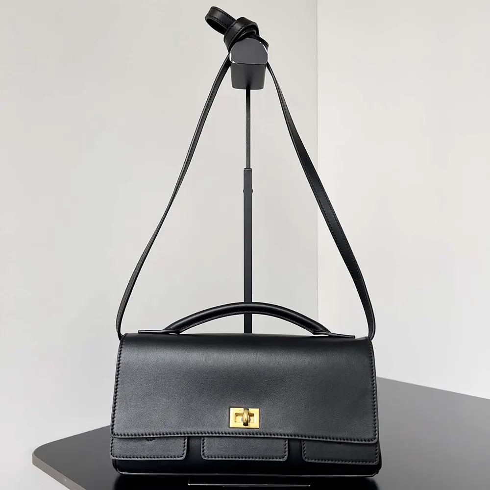 Side angle showing adjustable strap on Balenciaga Women Bel Air Clutch