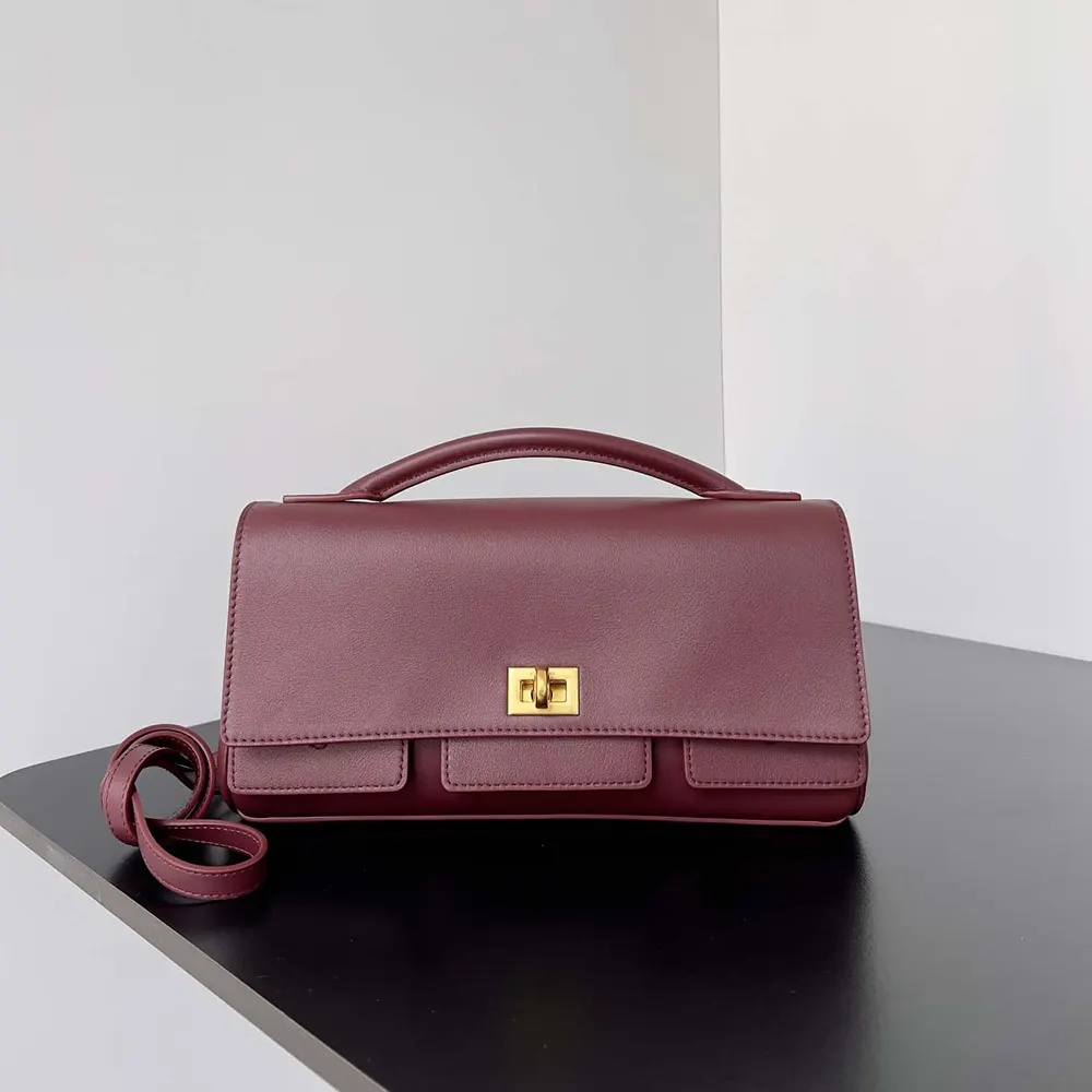Close-up on silver hardware and embossed logo of Balenciaga Bel Air clutch