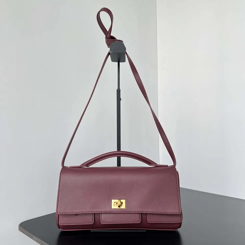 Side angle showing adjustable strap of Balenciaga Women Bel Air Clutch Small
