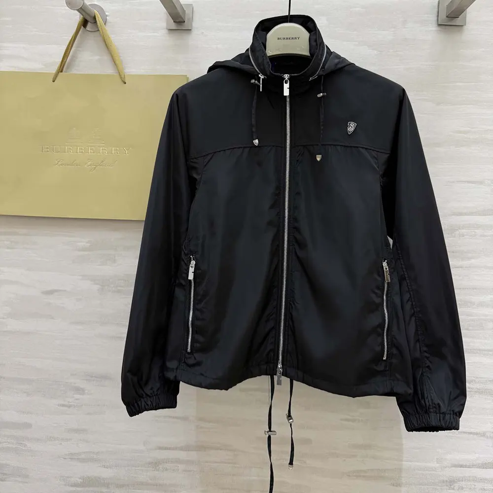 Close-up of embossed Knight stamp hardware on Burberry Men Knight Stamp Nylon Jacket-Black