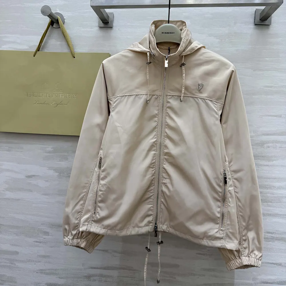 Close-up of silver-tone Burberry hardware on pink nylon cotton jacket