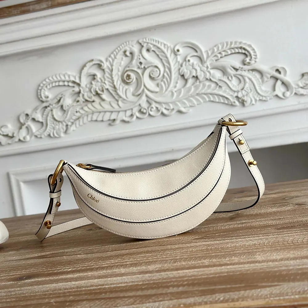 Close-up of gold-tone hardware and white leather texture on Chloe Women Banana Cross-body Bag