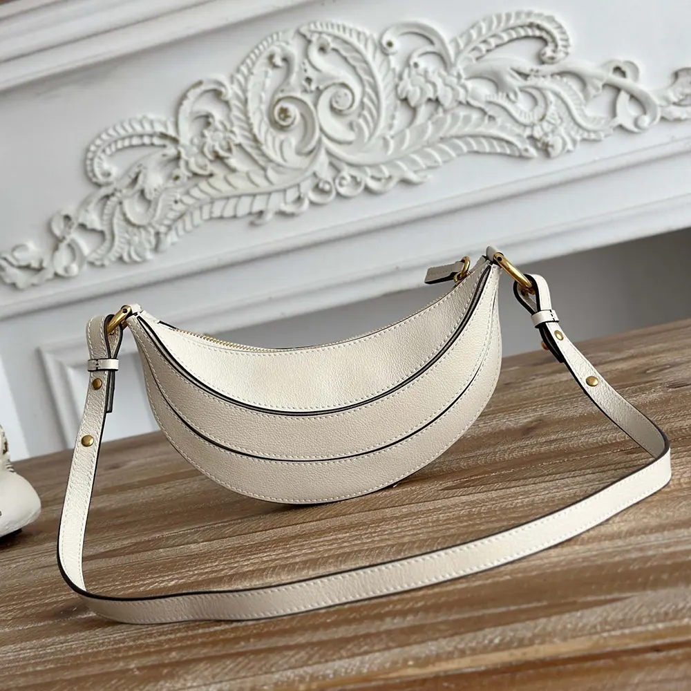 Side profile showing adjustable strap on Chloe Women Banana Cross-body Bag in White