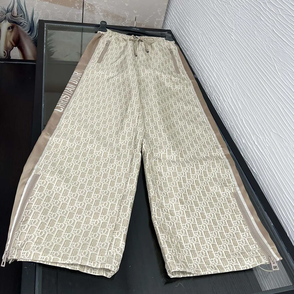 Close-up detail of Dior Oblique motif on the flared pants