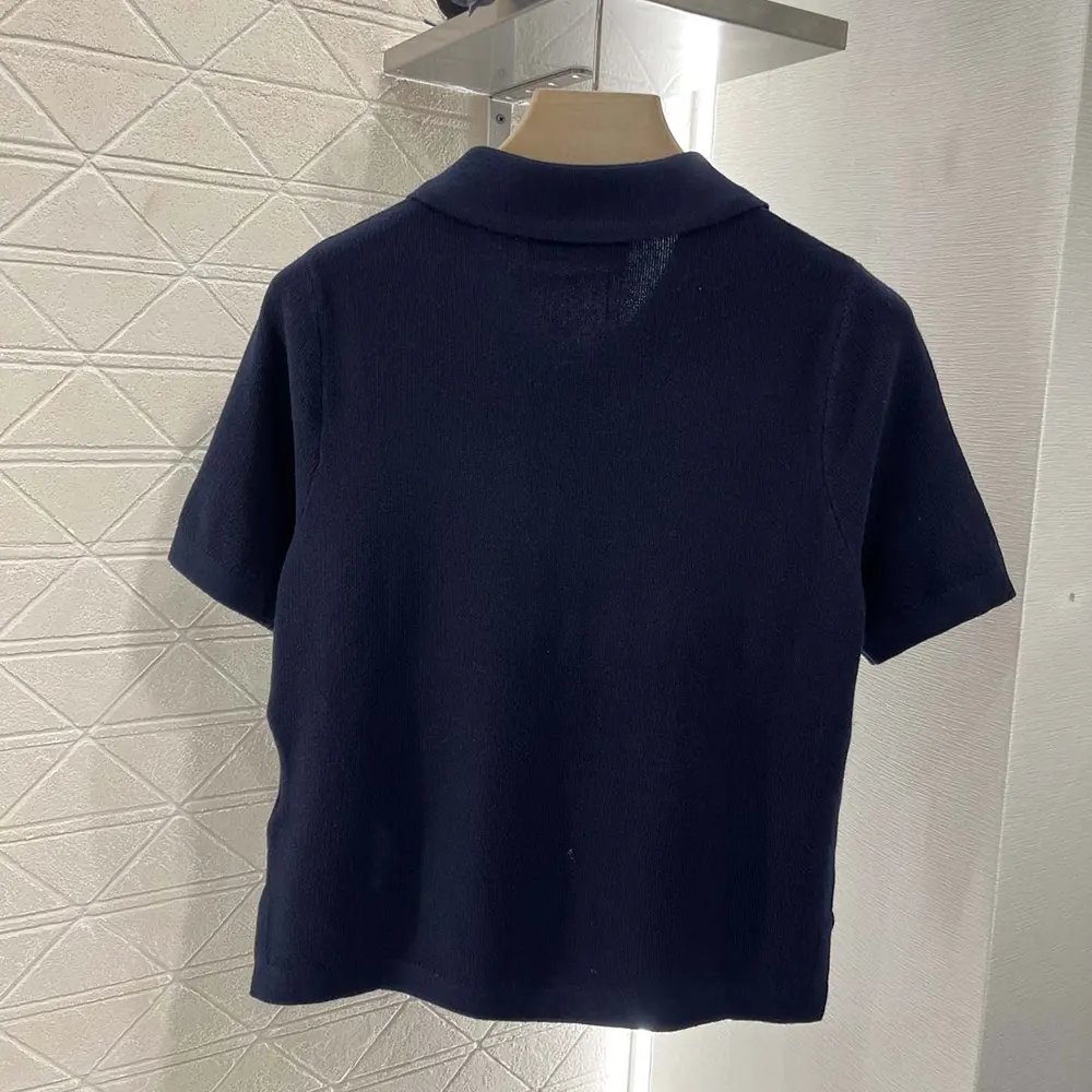 Side angle of Miu Miu Women Cotton Piqué Polo Shirt highlighting silhouette