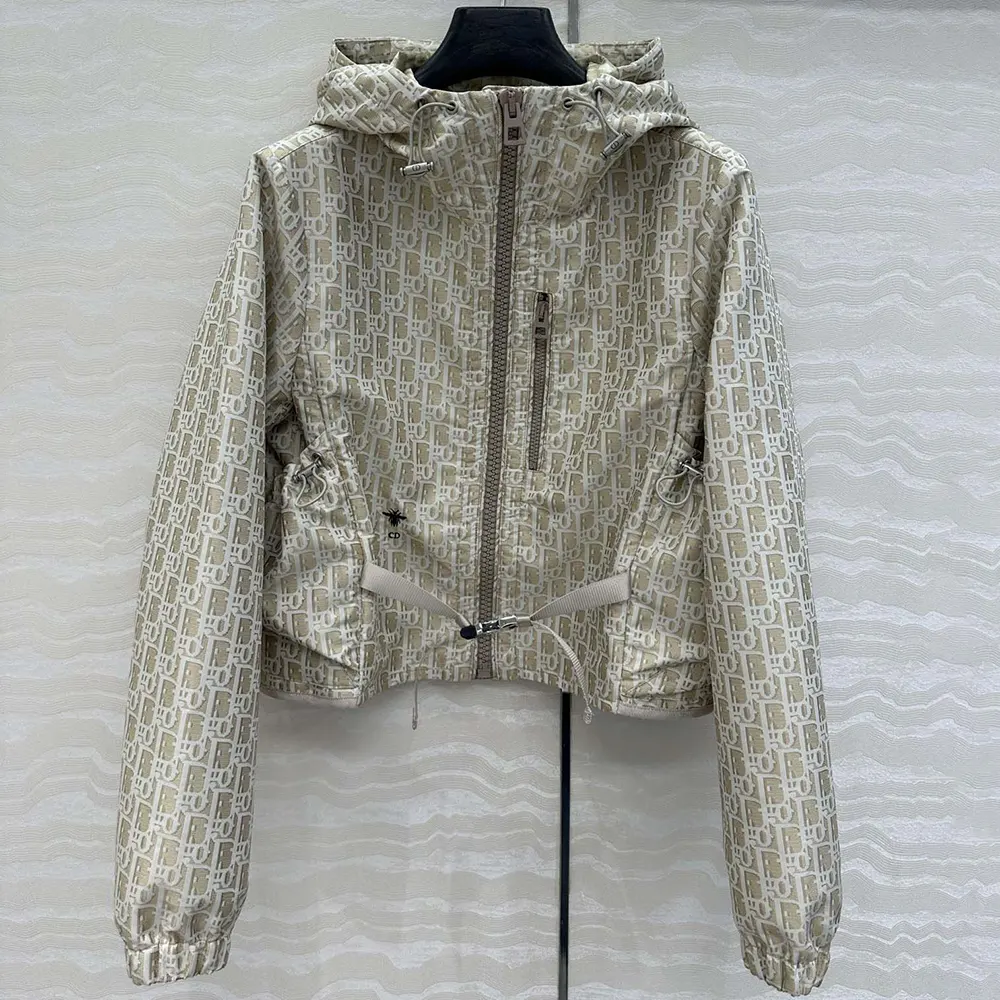 Close-up of Dior Oblique motif and zip hardware on beige jacket