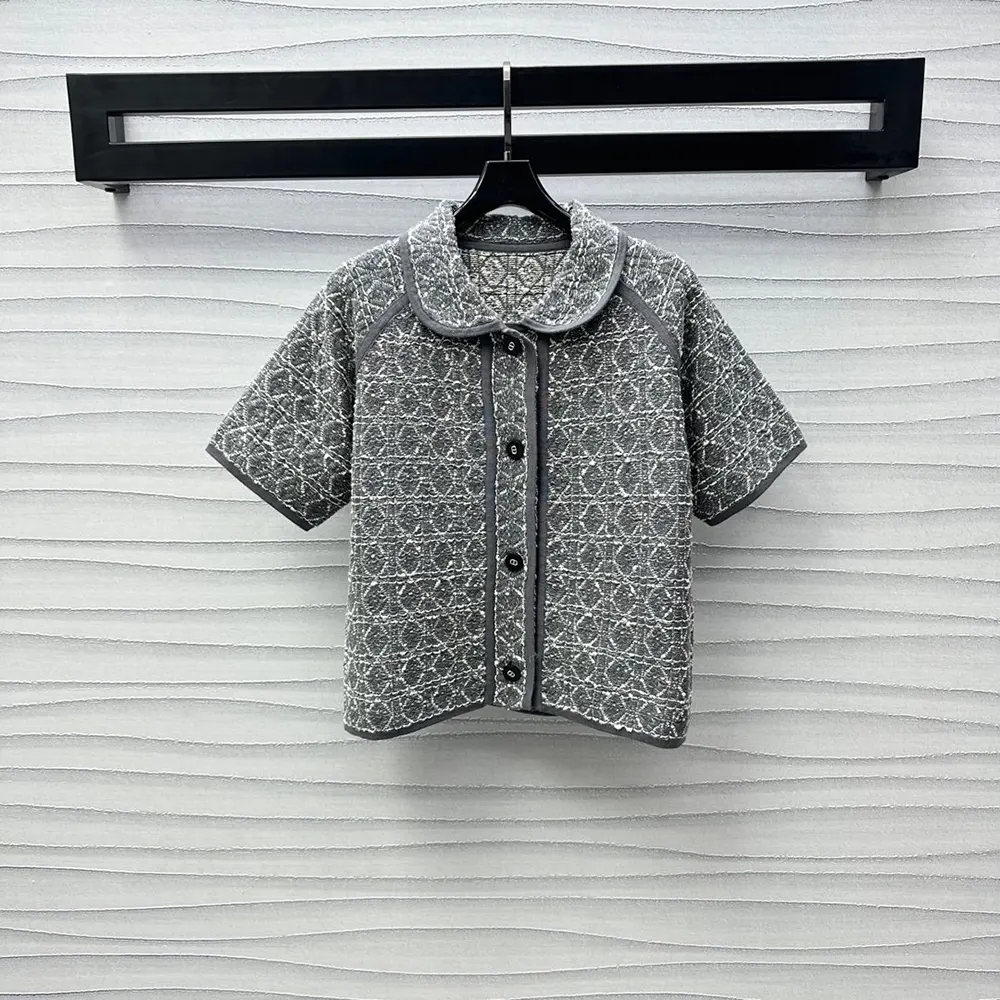 Close-up of Dior signature Macrocannage quilting on gray tweed jacket