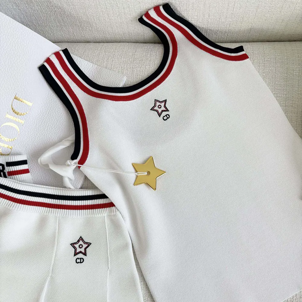 Close-up on three-tone signature embroidery on white mesh tank top
