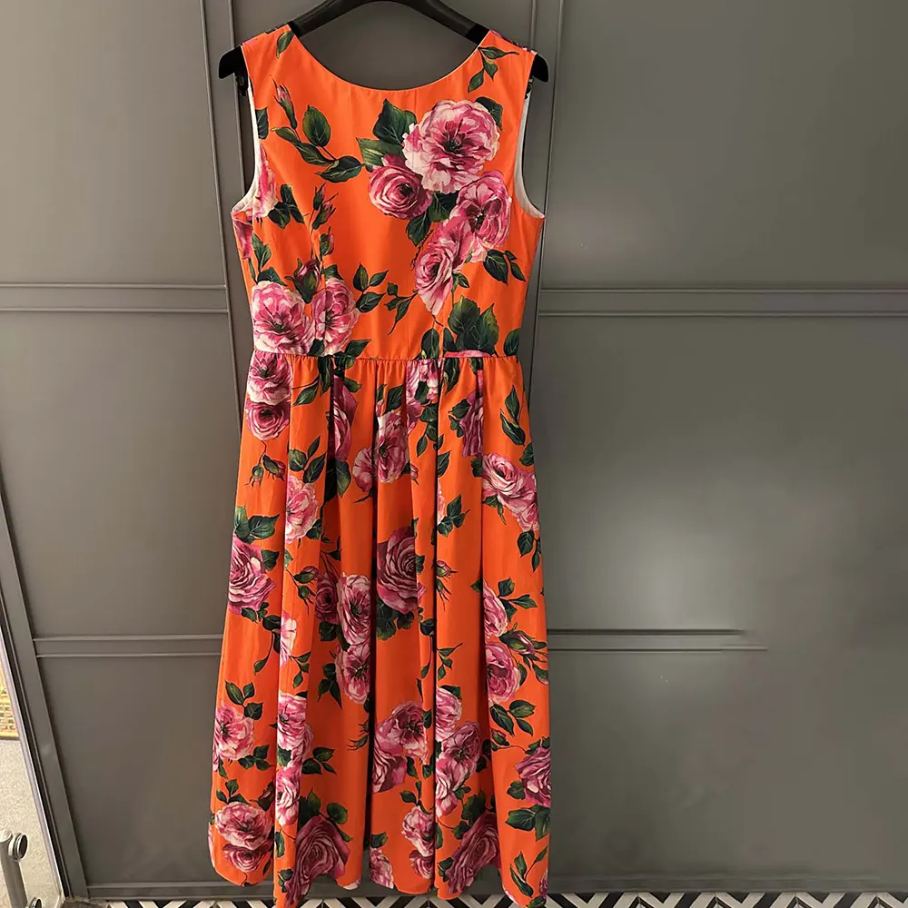 Side profile showing silhouette of Dolce Gabbana D&G Women Cotton Babydoll Dress in orange