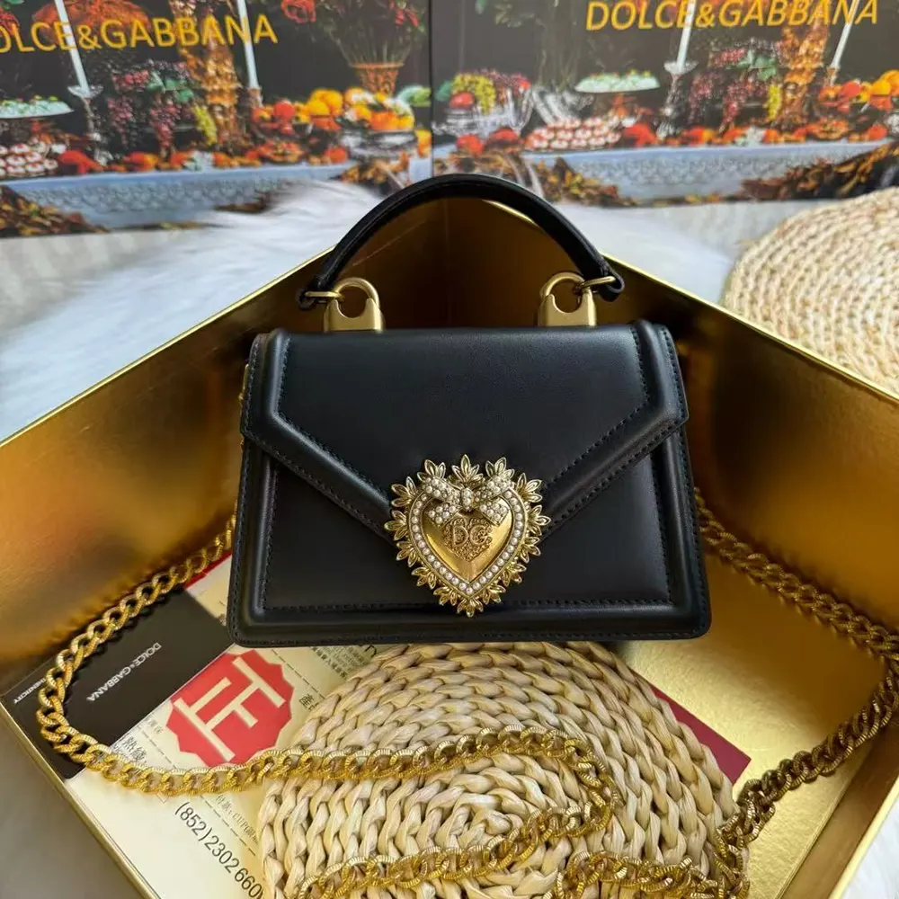 Close-up of gold heart clasp on Dolce Gabbana D&G Devotion Bag black leather
