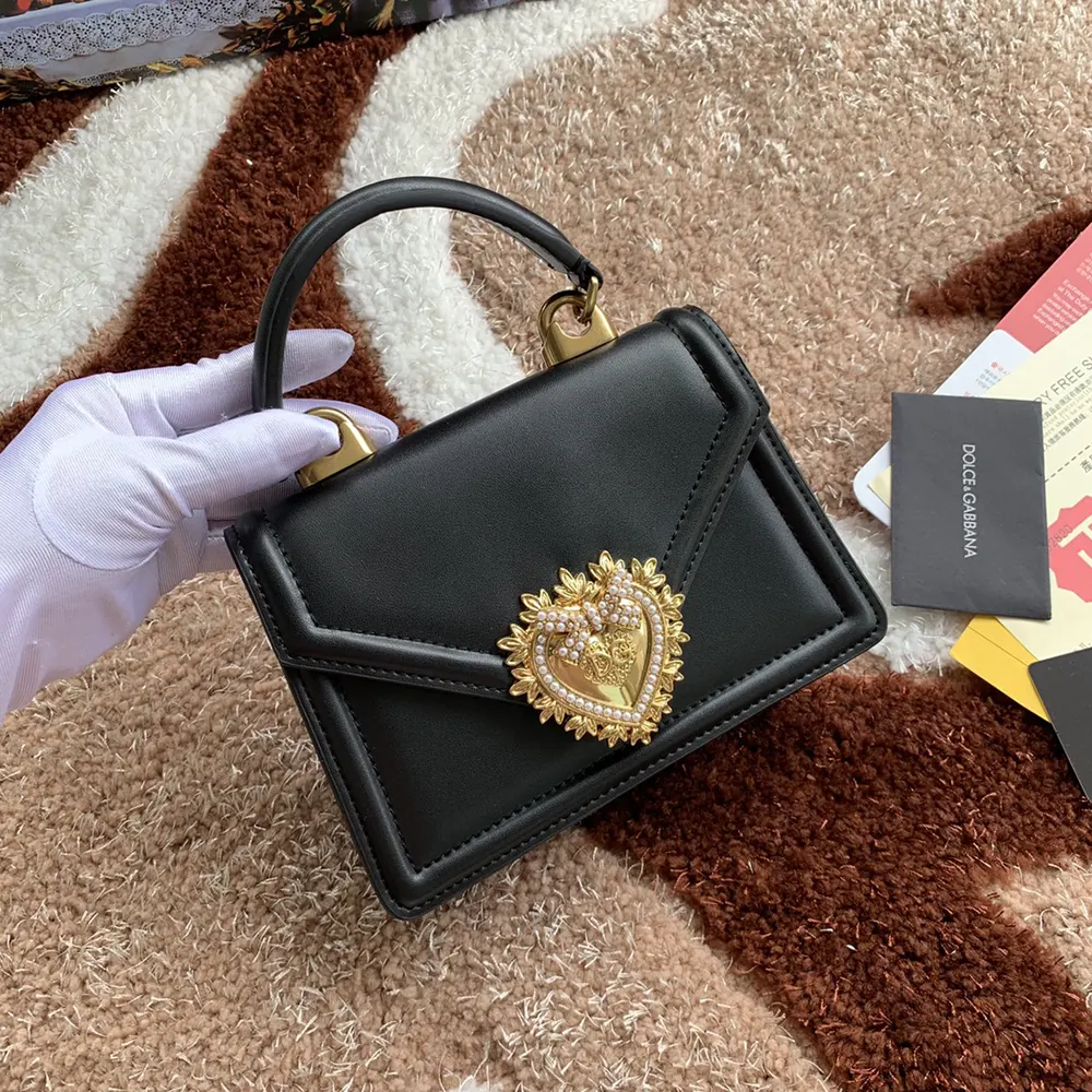 Close-up of gold heart clasp on Dolce Gabbana D&G Devotion Bag black calfskin