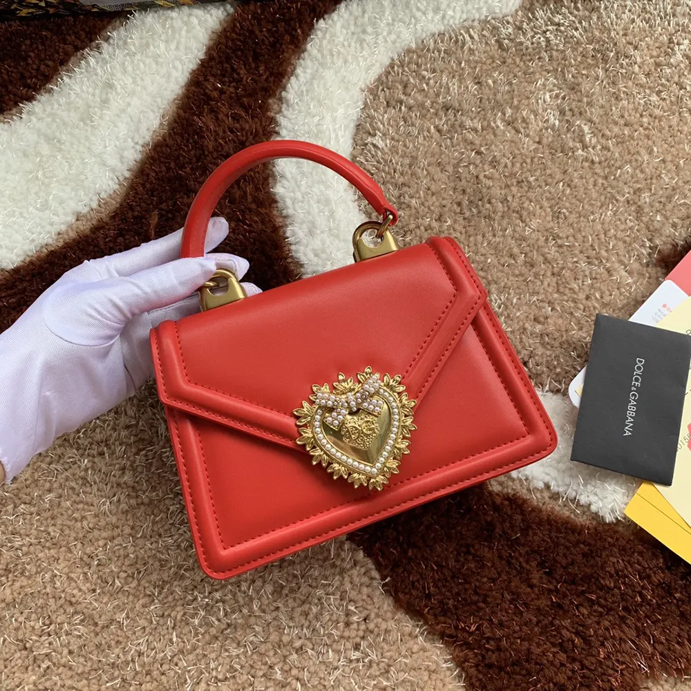 Side angle showing structured silhouette of Dolce Gabbana D&G red shoulder bag