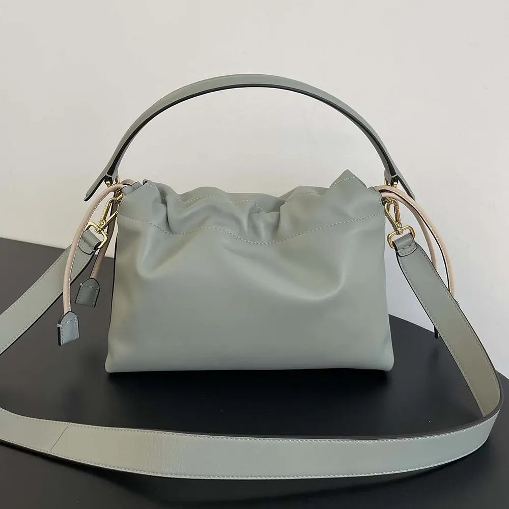 Side profile showing compact silhouette of Fendi Women Mamma Baguette mini-bag