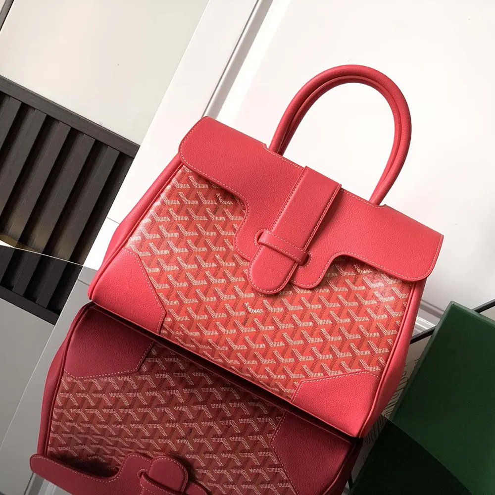 Close-up of pink leather trim and gold hardware on tote bag
