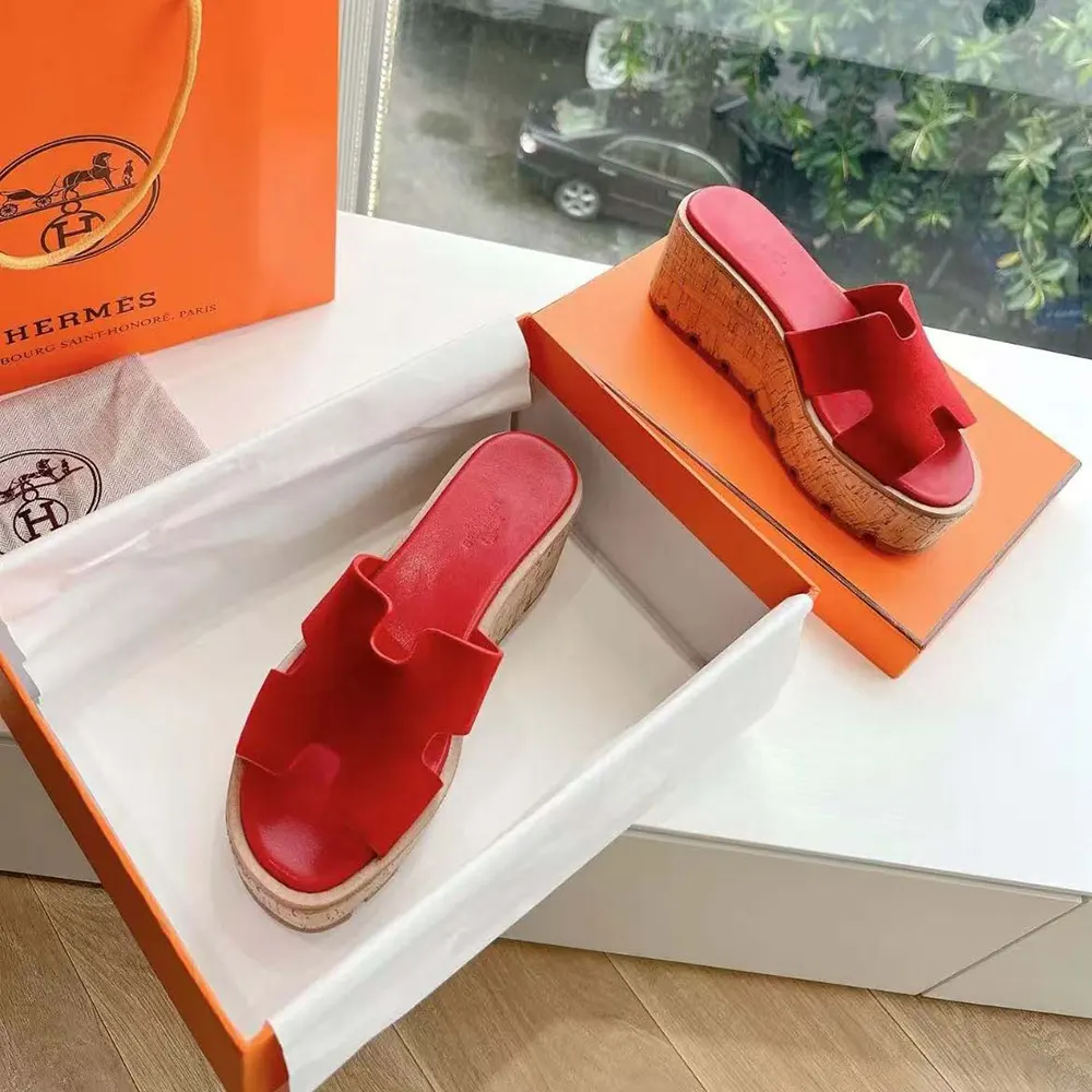 Close-up of red leather and signature cutout on Hermes Women Eze 30 Sandal-Red