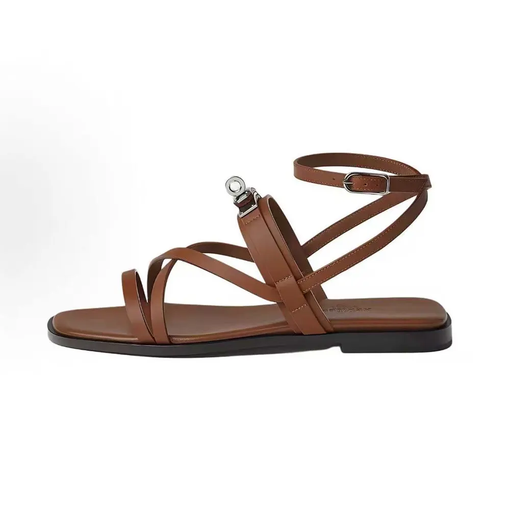 Side view of Hermes Women June Sandal in Calfskin-Brown showing signature cutout