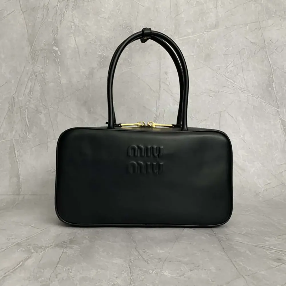 Close-up of silver-tone hardware on Miu Miu Women Beau Leather Top-handle Bag-Black