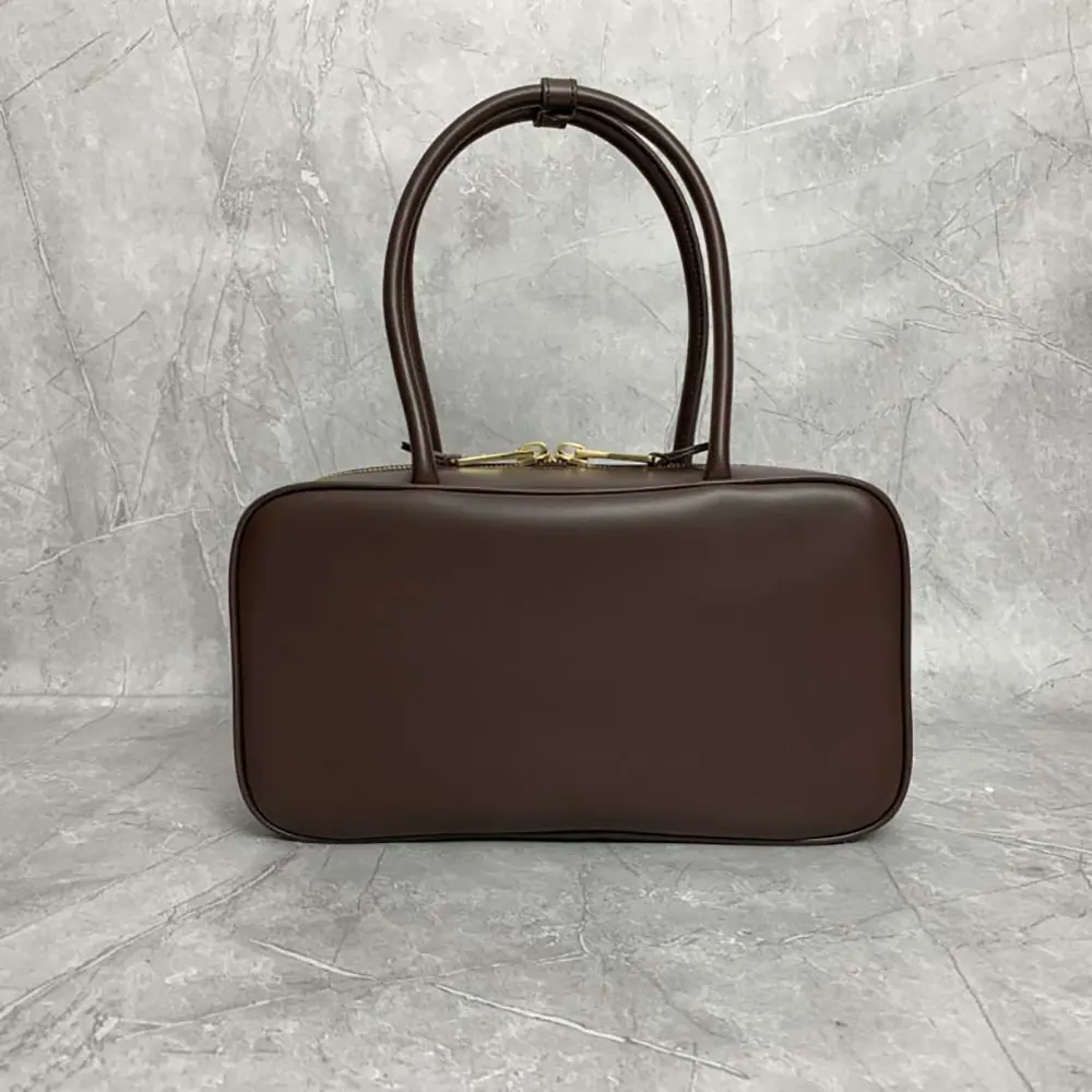 Side angle showcasing silhouette of Miu Miu Women Beau Leather Top-handle Bag-Briarwood