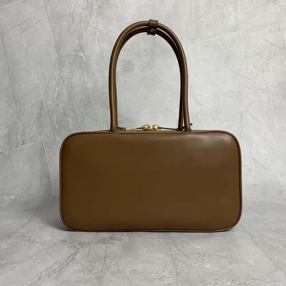 Side angle highlighting silhouette of Miu Miu Women Beau Leather Top-handle Bag-Brown