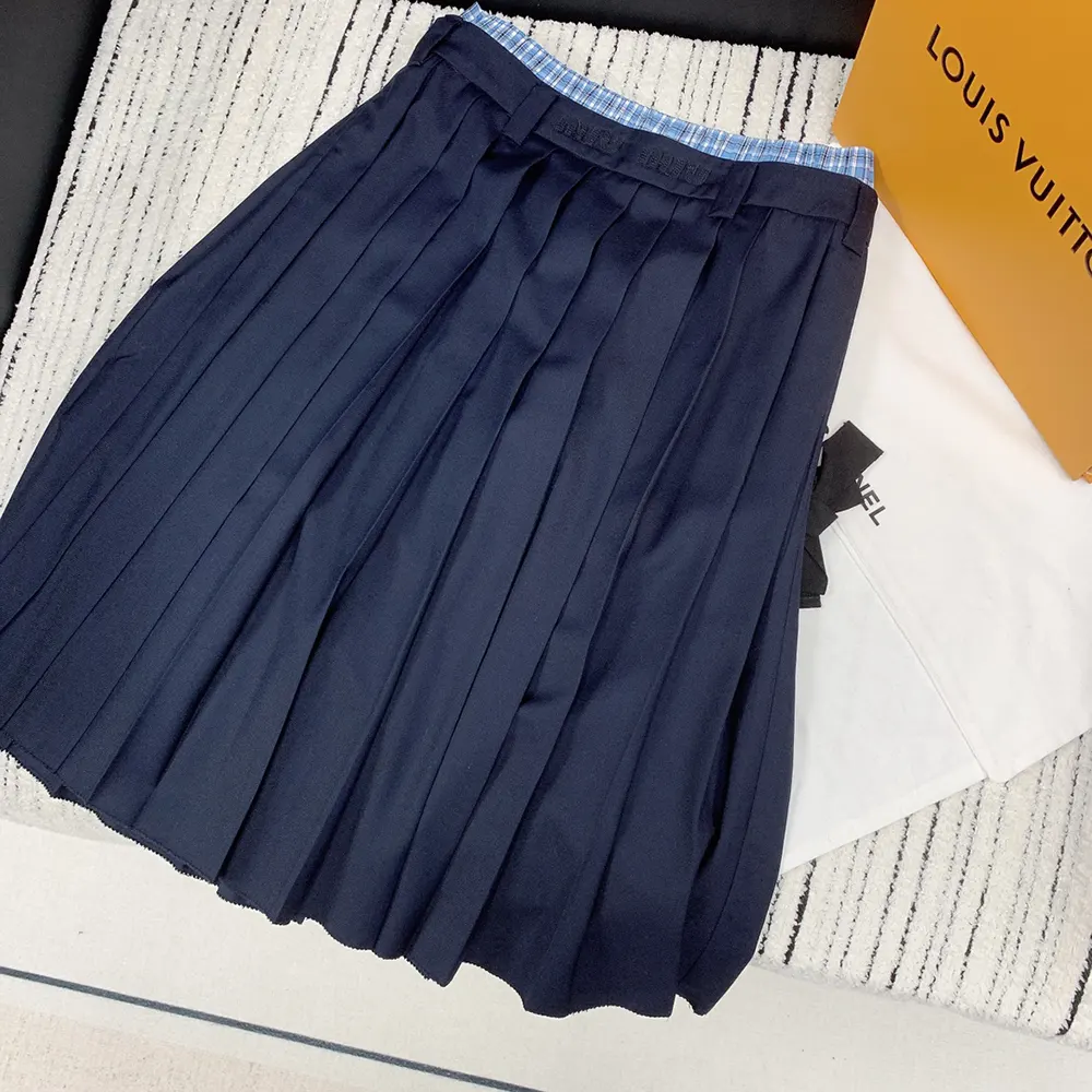 Close-up of navy Batavia pleated fabric on Miu Miu midi-skirt