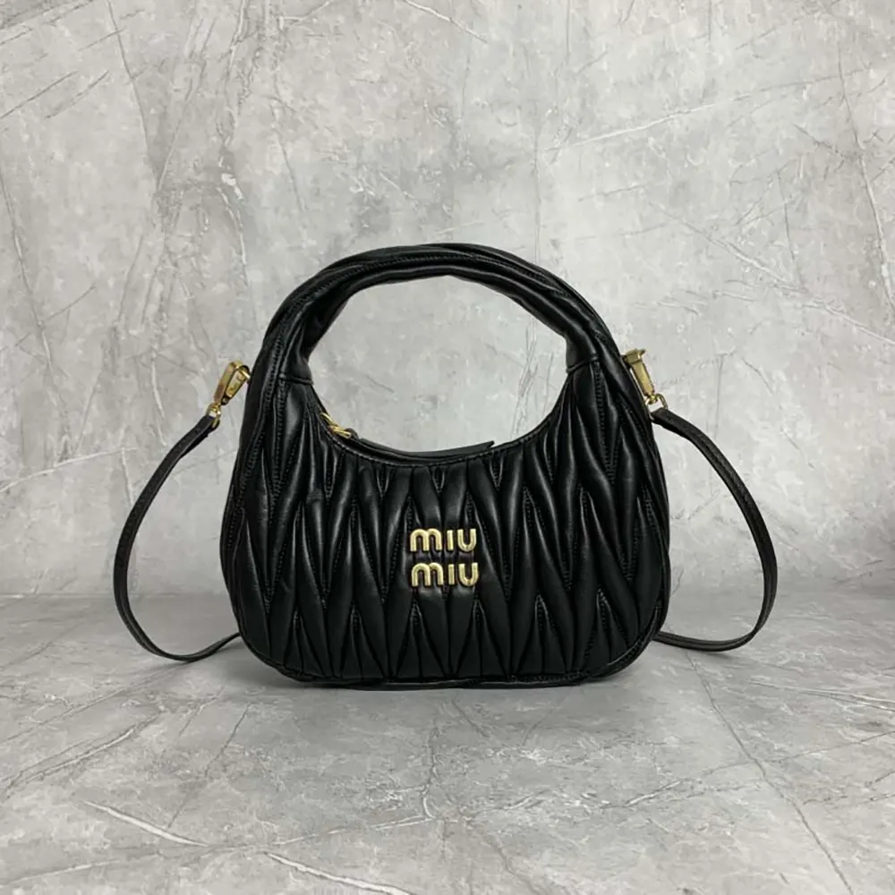 Close-up on quilted matelassé leather texture of Miu Miu Wander Hobo Bag
