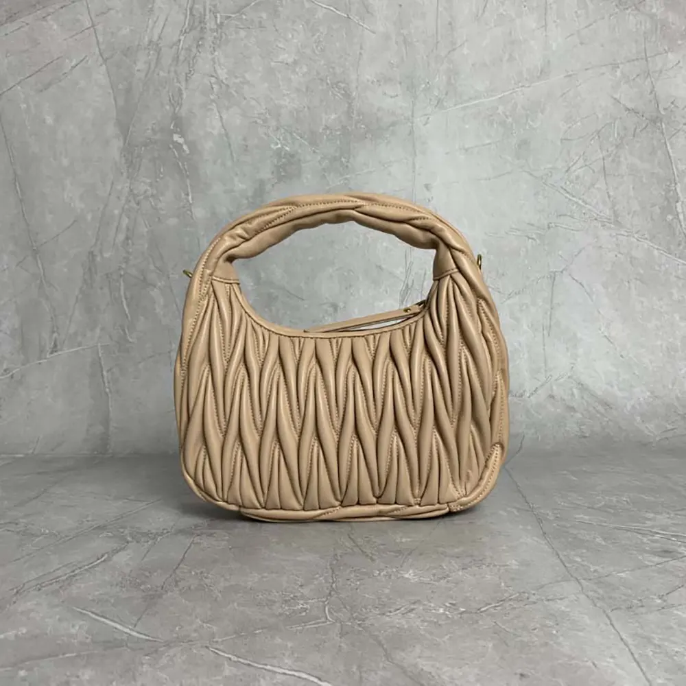 Side angle showing gold-tone hardware on Miu Miu Women Wander leather bag
