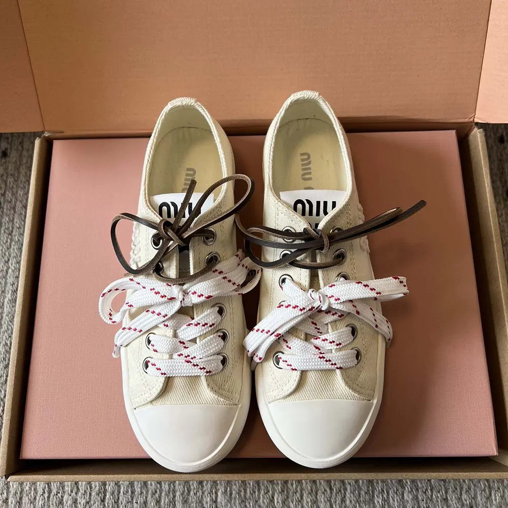 Close-up of signature logo hardware on Miu Miu Women Washed Denim Sneakers-White