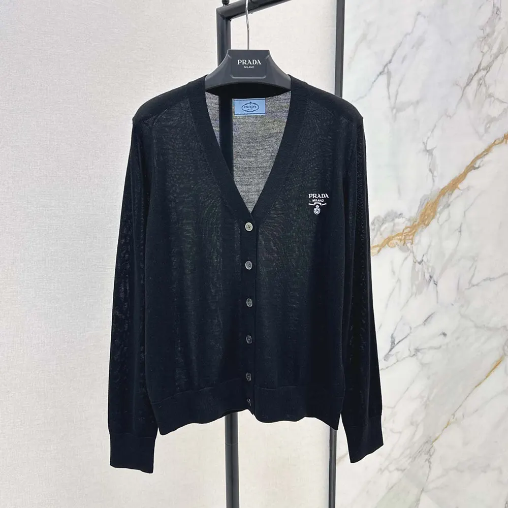 Close-up of signature Prada buttons on cashmere cardigan black