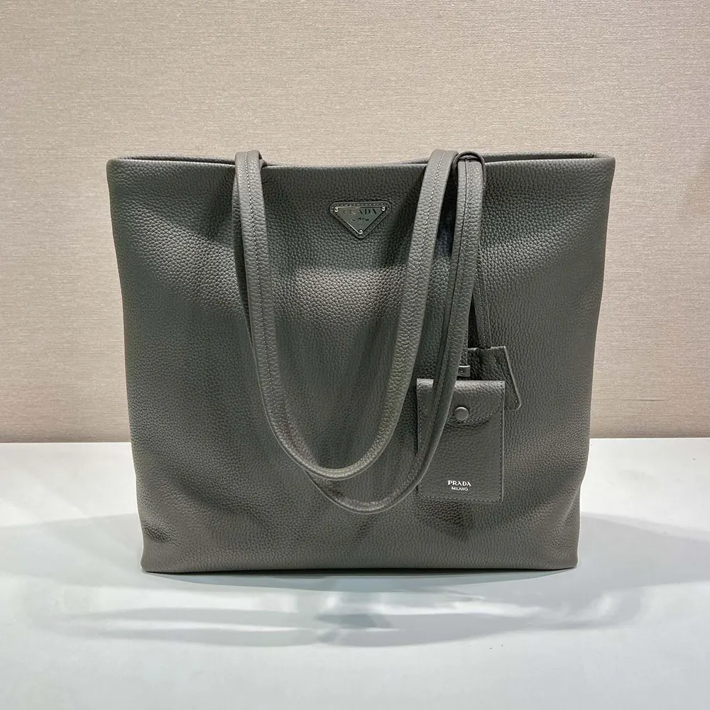 Close-up on bamboo handle and brushed gold hardware of Prada tote