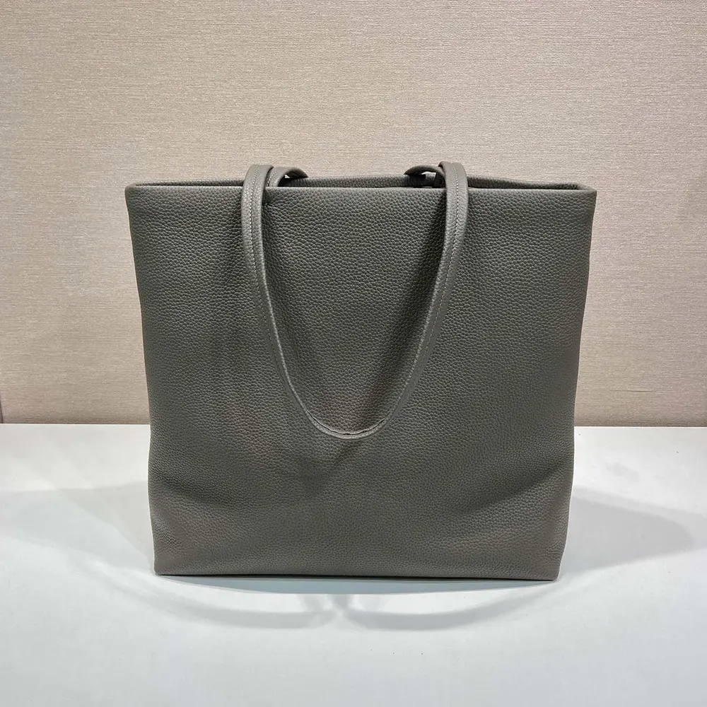 Side angle showing silhouette and gray leather texture of Prada unisex tote