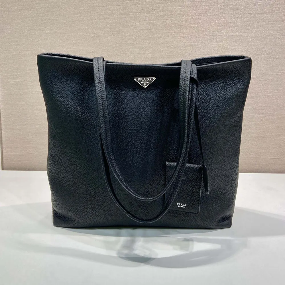Close-up on Prada logo hardware and smooth leather texture