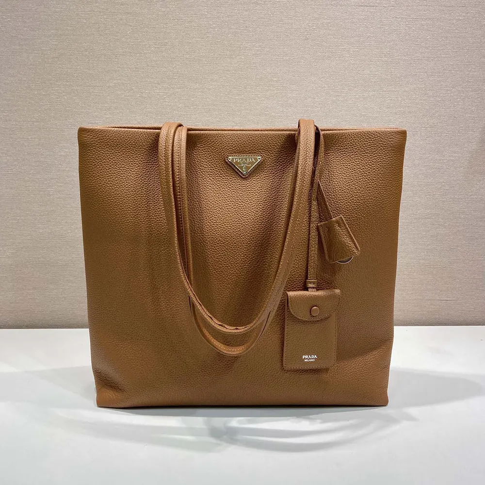 Close-up of Prada gold-tone hardware on brown leather tote
