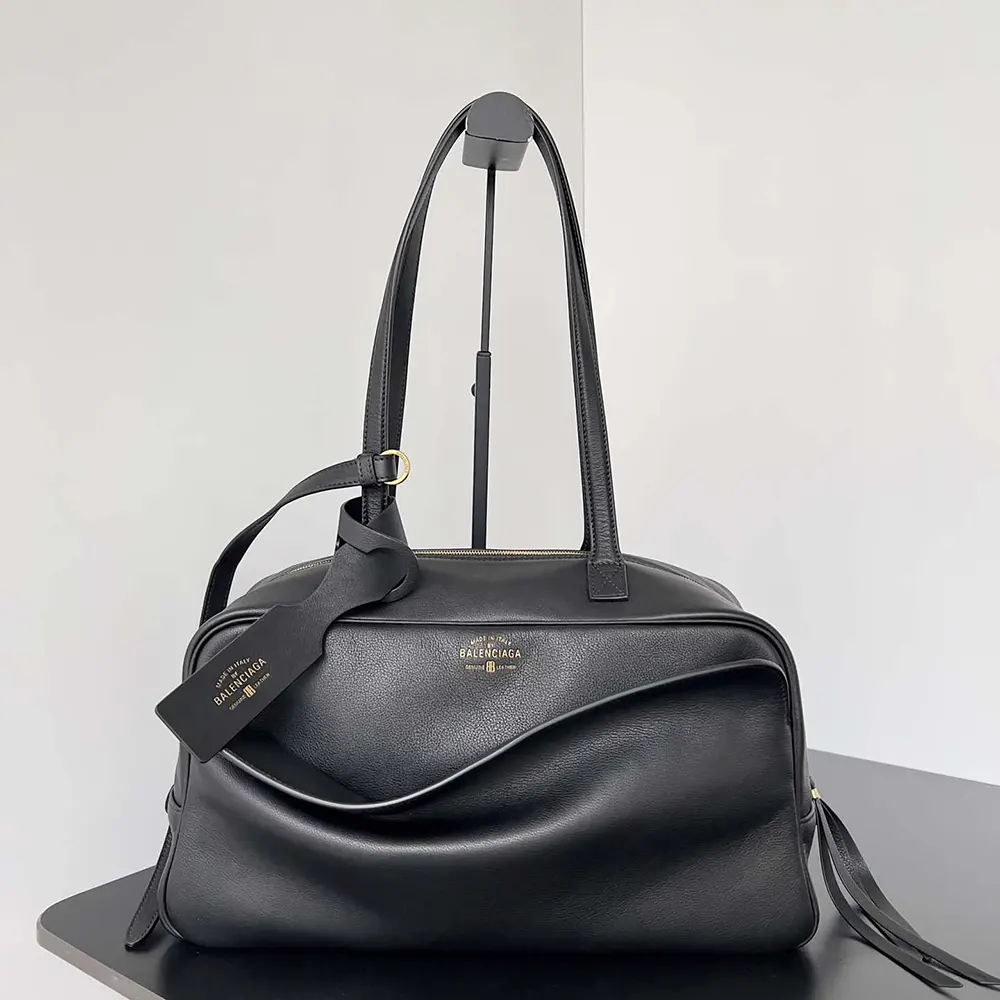 Close-up of silver-tone Prada logo hardware on Carrie Bowling Bag