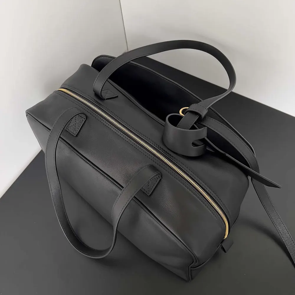 Side angle showing structured silhouette of Prada Women Carrie Bowling Bag