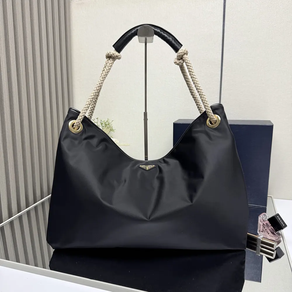 Close-up of black Re-Nylon fabric and silver hardware on Prada bag
